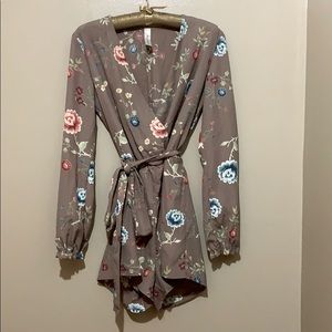 Romper with belted waist and lined top.